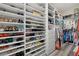 Custom designed walk-in closet with ample shelving, drawers, and hanging space for organization at 3415 Big Sky Way, Bradenton, FL 34211