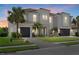 Stunning two-story home with a tile roof, lush landscaping, and a spacious driveway leading to a three-car garage at 3415 Big Sky Way, Bradenton, FL 34211