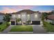 Elegant two-story home boasting lush landscaping, a tile roof, and a welcoming entryway at 3415 Big Sky Way, Bradenton, FL 34211