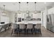 Modern kitchen featuring a large center island, pendant lighting, and stainless steel appliances at 3415 Big Sky Way, Bradenton, FL 34211