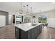Open concept kitchen with a large island, pendant lighting, and views of the Gathering room at 3415 Big Sky Way, Bradenton, FL 34211