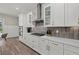 The elegant kitchen features white cabinets, stainless appliances, and stylish subway tile backsplash at 3415 Big Sky Way, Bradenton, FL 34211