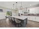 Spacious kitchen featuring a large island, stainless steel appliances, and stylish pendant lighting at 3415 Big Sky Way, Bradenton, FL 34211