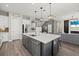 Stylish kitchen with gray island, stainless steel appliances, and an open layout to the living area at 3415 Big Sky Way, Bradenton, FL 34211