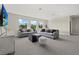 Bright living room with plush seating and large windows offering a scenic view at 3415 Big Sky Way, Bradenton, FL 34211