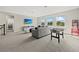 Spacious living area with a comfortable sofa, entertainment center, and natural light at 3415 Big Sky Way, Bradenton, FL 34211