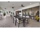 Bright patio area with ceiling fans, a bar, and tables for entertaining at 3415 Big Sky Way, Bradenton, FL 34211
