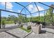 Relaxing screened-in patio with comfortable seating, lush landscaping, and a peaceful ambiance for outdoor enjoyment at 3415 Big Sky Way, Bradenton, FL 34211