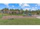 Community playground with swings and climbing structure, set on a green lawn, offers a fun space for children at 3415 Big Sky Way, Bradenton, FL 34211