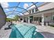 Sparkling screened pool features a full summer kitchen, and outdoor dining and lounging areas at 3415 Big Sky Way, Bradenton, FL 34211
