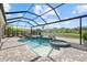 A screened pool and spa overlook the water providing a serene and private backyard oasis at 3415 Big Sky Way, Bradenton, FL 34211