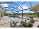 Beautiful screened-in pool and spa area with comfortable lounge seating and scenic water views for relaxation at 3415 Big Sky Way, Bradenton, FL 34211