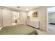 This light and bright bedroom features modern furnishings, gray floors, and a view to an en suite bathroom at 3605 Quail Hollow Ln, Bradenton, FL 34210