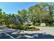 Landscaped entrance to the community with colorful flowers, lush greenery, and a prominent community sign at 3605 Quail Hollow Ln, Bradenton, FL 34210
