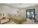 Cozy bedroom with access to the patio, a peloton bike, and stylish decor at 3605 Quail Hollow Ln, Bradenton, FL 34210