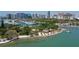 Aerial view showcases a beautiful marina and a beach with tiki hut at 3605 Quail Hollow Ln, Bradenton, FL 34210