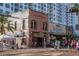 Street view of a brick building with shops and restaurants in a vibrant downtown area with pedestrian traffic at 3605 Quail Hollow Ln, Bradenton, FL 34210