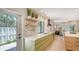 Open kitchen with sleek countertops, modern appliances, and an open view to the living area at 3605 Quail Hollow Ln, Bradenton, FL 34210