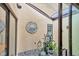 Charming indoor atrium with unique wall decor, potted plants, and natural light at 3955 Glen Oaks Manor Dr, Sarasota, FL 34232