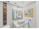 Contemporary bathroom with a unique vessel sink, speckled countertop, and modern lighting fixture at 3955 Glen Oaks Manor Dr, Sarasota, FL 34232