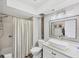 Bright bathroom showcasing a shower/tub combo, toilet, modern vanity, and unique light fixture at 3955 Glen Oaks Manor Dr, Sarasota, FL 34232