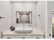 Modern bathroom features a vessel sink, granite countertop, and stylish square mirror at 3955 Glen Oaks Manor Dr, Sarasota, FL 34232