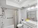 Bright bathroom offers a shower and tub combination and modern vanity with a large mirror at 3955 Glen Oaks Manor Dr, Sarasota, FL 34232