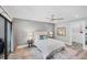 Light, airy bedroom features a queen bed with stylish decor, ceiling fan and wood-look flooring at 3955 Glen Oaks Manor Dr, Sarasota, FL 34232