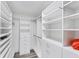 Bright walk-in closet provides ample hanging and shelf space for organized storage solutions at 3955 Glen Oaks Manor Dr, Sarasota, FL 34232