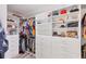 Spacious walk-in closet with custom shelving and ample storage space for clothes and accessories at 3955 Glen Oaks Manor Dr, Sarasota, FL 34232