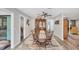 Bright dining room featuring stylish wood furniture, ceiling fan, and designer rug at 3955 Glen Oaks Manor Dr, Sarasota, FL 34232
