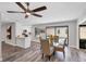 Open concept living with dining area, kitchen and view to the private pool area at 3955 Glen Oaks Manor Dr, Sarasota, FL 34232