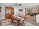 Cozy dining room with wood table set, ceiling fan, and view into living area at 3955 Glen Oaks Manor Dr, Sarasota, FL 34232