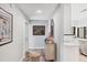 Bright entryway showcasing a modern console table and seamless flow to the kitchen at 3955 Glen Oaks Manor Dr, Sarasota, FL 34232