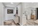 Inviting entryway leading to kitchen area, featuring modern console table and wood flooring at 3955 Glen Oaks Manor Dr, Sarasota, FL 34232