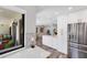 Modern kitchen with stainless steel refrigerator and views to the outdoor living area at 3955 Glen Oaks Manor Dr, Sarasota, FL 34232