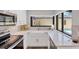 Bright kitchen featuring a farmhouse sink, modern appliances, quartz counters and views to the pool at 3955 Glen Oaks Manor Dr, Sarasota, FL 34232