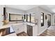 Bright kitchen featuring a farmhouse sink, modern appliances, quartz counters and views to the pool at 3955 Glen Oaks Manor Dr, Sarasota, FL 34232