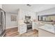 Modern kitchen with stainless steel appliances, white cabinets, and a view of the backyard patio at 3955 Glen Oaks Manor Dr, Sarasota, FL 34232