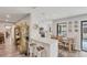 Bright kitchen with a breakfast bar, modern appliances, and an adjacent dining area with backyard views at 3955 Glen Oaks Manor Dr, Sarasota, FL 34232