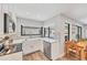 Well-appointed kitchen featuring white cabinets, stainless steel appliances, and a sink with a backyard view at 3955 Glen Oaks Manor Dr, Sarasota, FL 34232