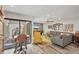 Well-lit living room with an open layout, modern furnishings, and a view of the outdoor courtyard at 3955 Glen Oaks Manor Dr, Sarasota, FL 34232