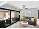 Bright living room with sliding glass doors to outdoor area, modern decor, and wood-look floors at 3955 Glen Oaks Manor Dr, Sarasota, FL 34232