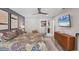 Well-lit main bedroom featuring a TV, view into an adjacent closet, and tasteful decor at 3955 Glen Oaks Manor Dr, Sarasota, FL 34232