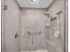Modern walk-in shower with gray tile surround, rain shower head, and grab bar at 3955 Glen Oaks Manor Dr, Sarasota, FL 34232