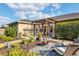 Beautifully landscaped backyard featuring a patio with a pergola and lounge area at 4211 Kingsfield Dr, Parrish, FL 34219