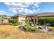 Lush backyard featuring a spacious lawn, mature trees, and a relaxing patio at 4211 Kingsfield Dr, Parrish, FL 34219
