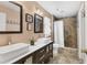 Bathroom with double vanity, tile flooring, and large tiled shower with glass door at 4211 Kingsfield Dr, Parrish, FL 34219
