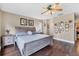 Bedroom with wood floors, decorative wall art, and a large bed with neutral bedding at 4211 Kingsfield Dr, Parrish, FL 34219