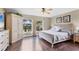 Bedroom featuring hardwood floors, large windows, and a decorative cabinet at 4211 Kingsfield Dr, Parrish, FL 34219
